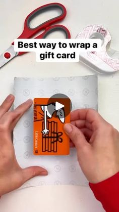 someone is cutting out a gift card with scissors