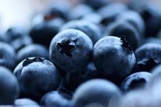 blueberries are piled up in a pile