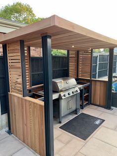 an outdoor kitchen with bbq and grill area