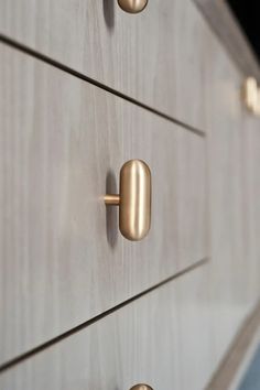 three drawers with brass handles and knobs on them