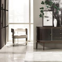 a living room scene with focus on the sideboard and chair in the foreground