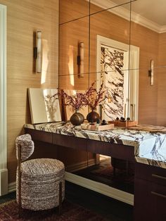 a desk with a mirror and chair in front of it