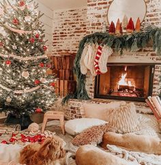 a woman laying on top of a bed next to a fire place in a living room