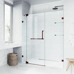 a white bathroom with a walk in shower next to a sink and mirror on the wall