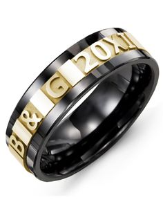 a black and gold wedding ring with the word b & g on it