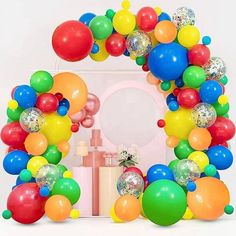 a bunch of balloons that are in the shape of a wreath on top of a table