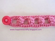 a crochet stitch with a button on it