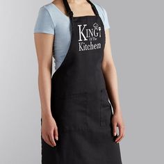 a woman wearing an apron with the words no one is here