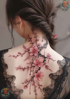 the back of a woman's neck with flowers on it