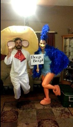 two people dressed in costumes standing next to each other holding signs that read pep pep