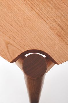 a close up of a wooden object on a white surface with no people around it