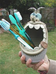 a toothbrush holder with several toothbrushes in it