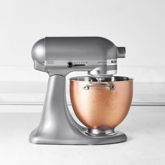 a silver and copper mixer on a white counter