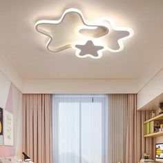 a child's bedroom with a star shaped ceiling light