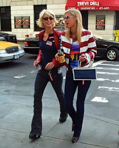 two women walking down the street talking to each other