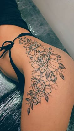 the back of a woman's thigh with flowers on it