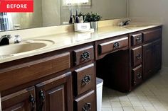 a bathroom with two sinks and a large mirror above the sink is white tile flooring