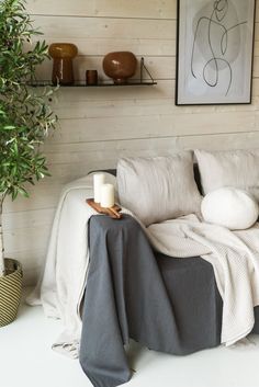 a white couch sitting next to a potted plant