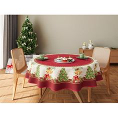 a dining room table covered with a christmas themed tablecloth and two chairs in front of it