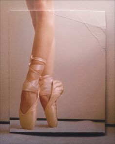 the legs and feet of a ballerina in ballet shoes