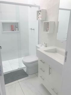 a bathroom with a toilet, sink and shower stall is pictured in this image from the front view