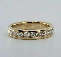 a yellow gold wedding band with five diamonds