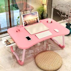 a pink computer desk with a laptop on it