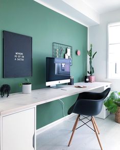 an instagram page with a green wall and white desk