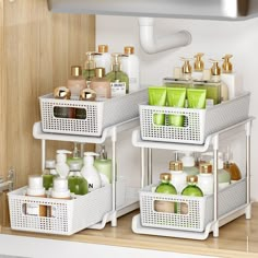 three white baskets filled with different types of soaps and lotions on top of a shelf