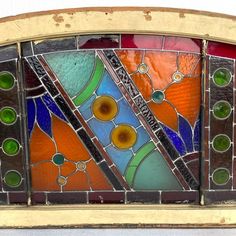 an old stained glass window with many different colors