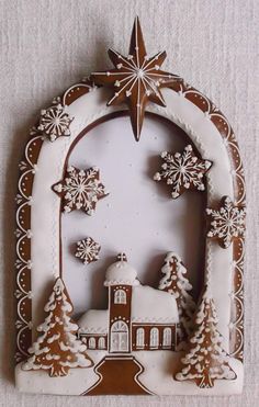 a white and brown christmas ornament with snowflakes on it's sides