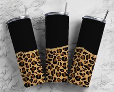 three personalized leopard print tumblers with matching black and gold trim on marble background