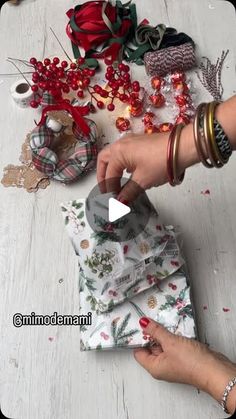 a woman is making christmas decorations on the floor