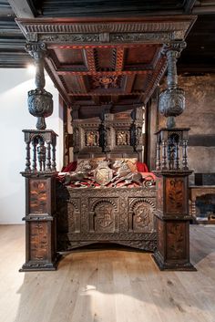 an ornate wooden bed with intricate carvings on the headboard