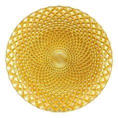 an intricately designed yellow glass plate on a white background with no people around it