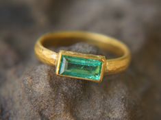 "24k gold emerald ring//artisan emerald ring//emerald 24k ring//24k gold ring//24k gold hand made emerald ring//artisan gold emerald ring By far emeralds are my favorite stones , even being soft and fragile they never bore me specially with the sun shining into them. with the 24k gold the green is just greener sdfa stone is beautiful emerald ( Zambia )9X4.5 mm 1 ct weight I used 24k gold for the setting and 22k for the rest of the wire ring (width 3.6 mm , 0.15\") I can do matching studs, pendan 22k Gold Emerald Gemstone Ring As Gift, Handmade Yellow Gold Emerald Ring For May Birthstone, Artisan Diamond Rings, Opal Bracelet Gold, Gold Emerald Ring, Smaragd Ring, Kyanite Ring, Raw Gemstone Ring, Emerald Ring Gold