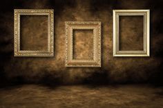 an empty room with three frames on the wall