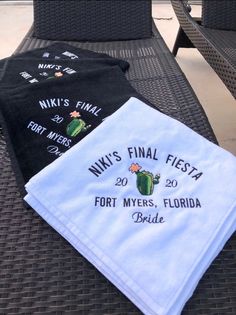 three towels sitting on top of a table next to each other with the names of their respective event