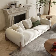 a living room filled with furniture and a fire place next to a white wall mounted fireplace