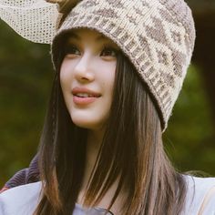 a young woman wearing a knitted hat