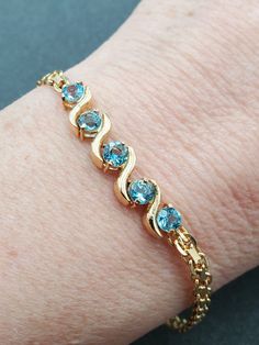 Lovely, HSN Designer, Round Cut Blue Topaz Yellow Gold Over 925 Sterling Silver 5 Stone Chain Bracelet. This beautiful bracelet is sure to receive many compliments! YELLOW GOLD OVER SOLID 925 STERLING SILVER. Length: 7.5" Width: 6.5mm Gemstone: Blue Topaz Weight: 6.8 Grams Hallmarked: ☆ / 925 We gladly combine shipping! Everything is packed with care to make sure it arrives safely. We only sell authentic items. If it is a name brand item, we guarantee it to be authentic. If it is made of preciou Topaz Yellow, John 3 16, Chain Link Bracelet, Solid 925 Sterling Silver, Sterling Silber, Beautiful Bracelet, Precious Metals, Chain Bracelet, Blue Topaz