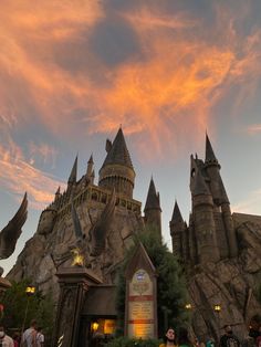 the wizard's castle is lit up at sunset