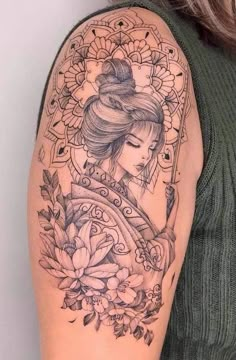 a woman with a tattoo on her arm holding a pipe and flowers in front of her face