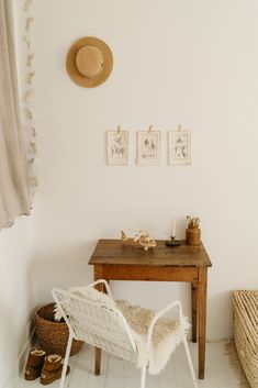 a chair and table in a room with pictures on the wall above it, along with other items