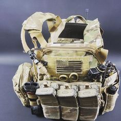 an army style backpack with multiple items attached to the front and side pockets, all in different colors