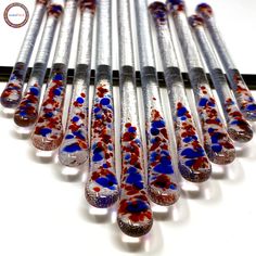 a group of red, white and blue glass tubes sitting on top of a table