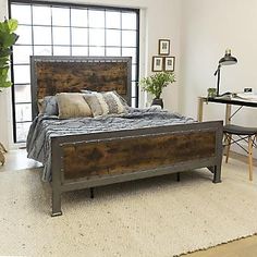 a bed sitting on top of a wooden floor next to a window