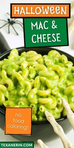 halloween macaroni and cheese in a black bowl on a white table with text overlay