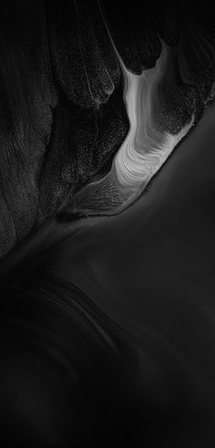 black and white photograph of water flowing down the side of a mountain