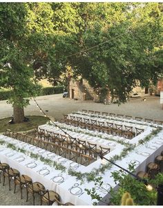 tables set up for an outdoor event under trees